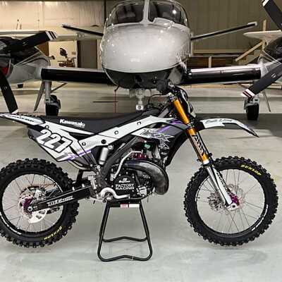 DeCal Works Custom Dirt Bike with white and black graphics, a purple accent and Kawasaki Logos