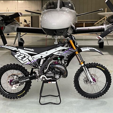 DeCal Works Custom Dirt Bike with white and black graphics, a purple accent and Kawasaki Logos